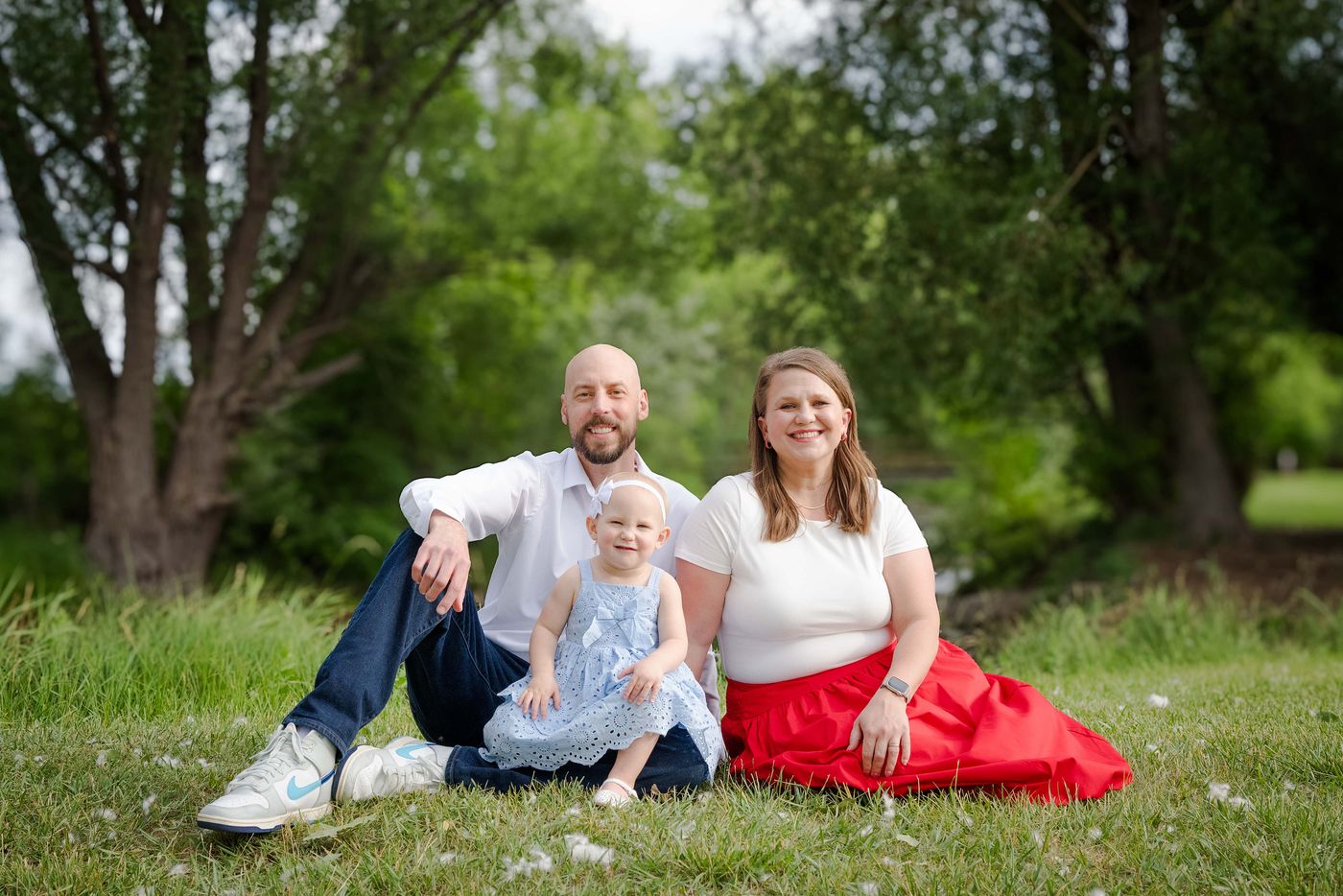 Michael and Jennifer Calabrese with their daughter on the grass in a Rapid City park